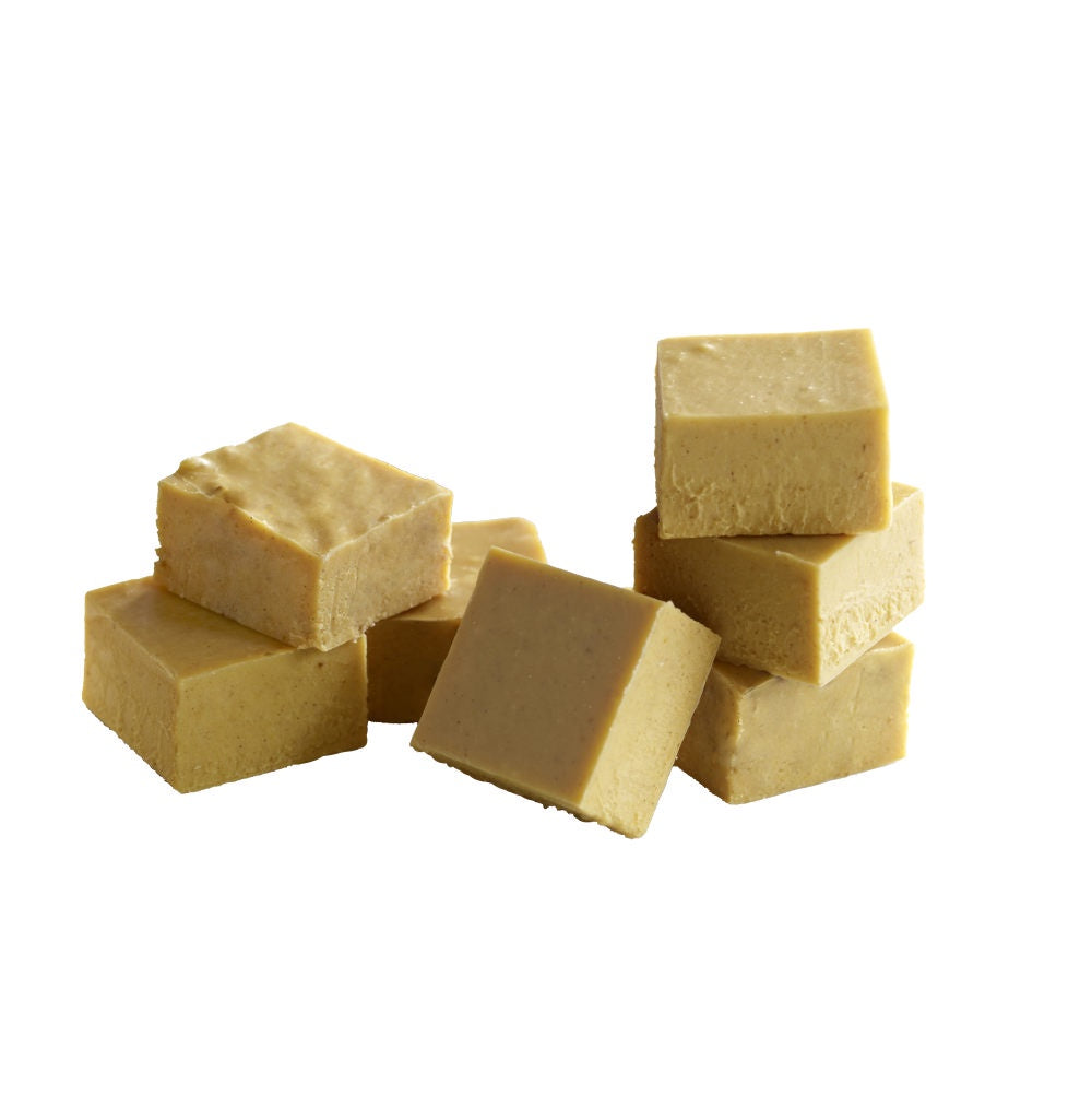 image of several square piece of fudge in a light golden color with tiny flecks of cinnamon