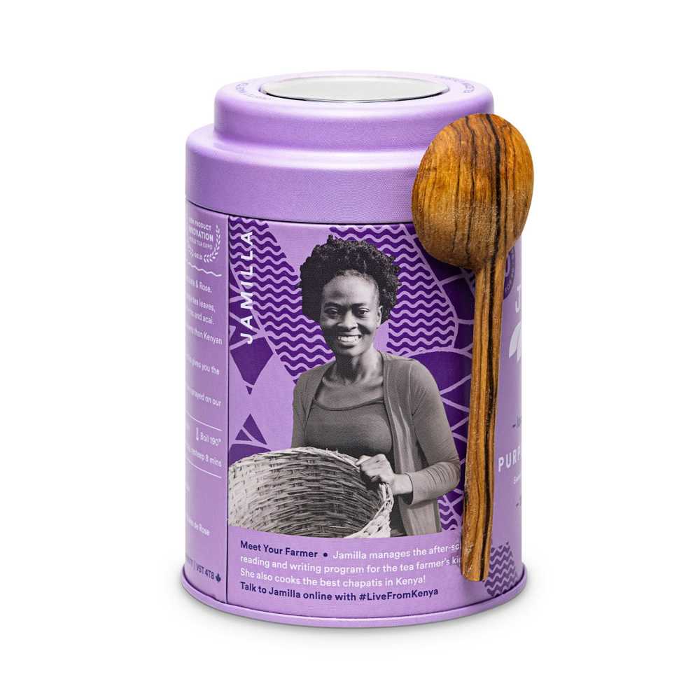image of a round tea tin in a purple color with a carved wooden spoon, featuring a black and white image of Jamilla, one of the tea farmers