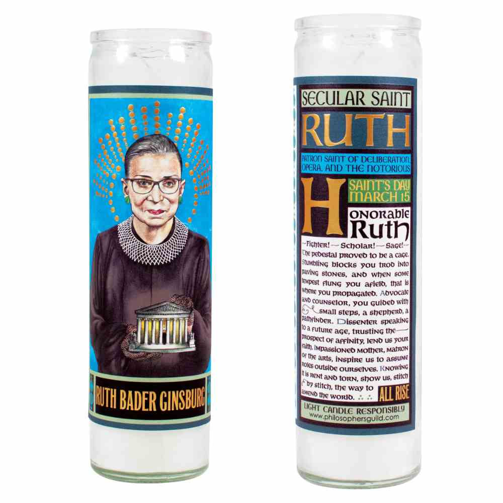 image of tall glass candle with labels.  On the left shows the front with a drawing of RBG holding a small supreme court building, on the back is a long description and prayer