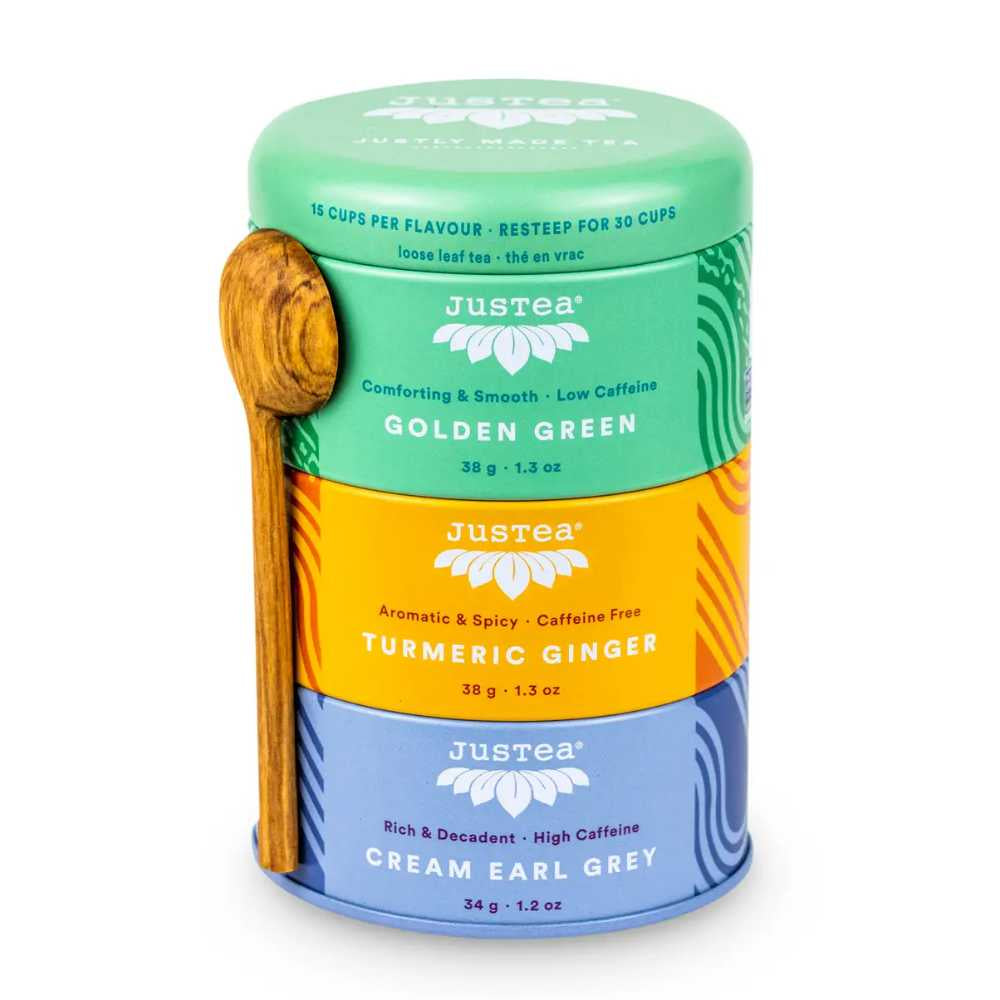 image of tall round tea tin in three sections with lid.  Lid and top section is a bright medium green, center section is a bright orange yellow, bottom section is a medium blue.  Justea logo on each section with descriptions of tea that is in each tin.