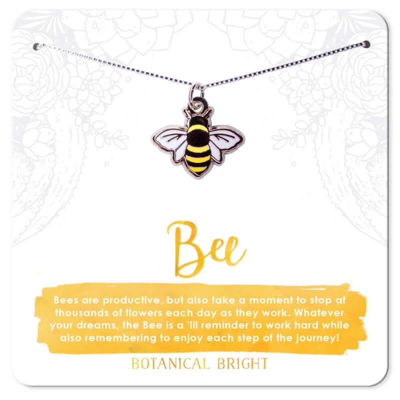 image of bee enamel charm on a thin silver chain.  On a white card with yellow