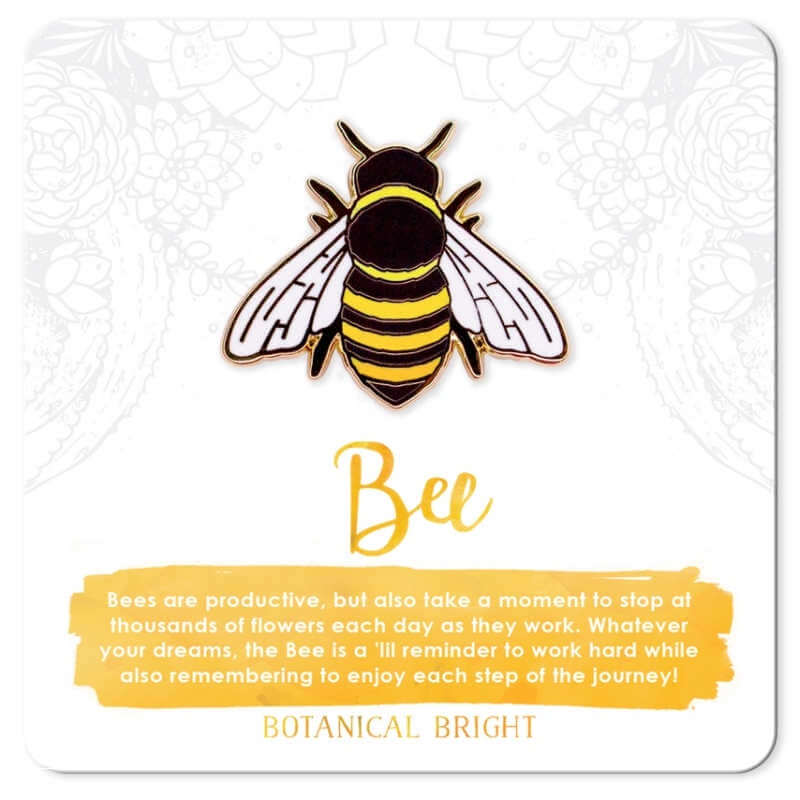 image of bee enamel pin on a white card with yellow writing