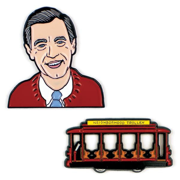 image of two pins.  one of Mr Rogers upper body with sweater and tie, the other of a red trolley