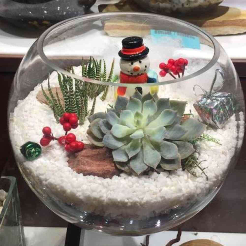 image of glass globe terrarium with miniature holiday decorations