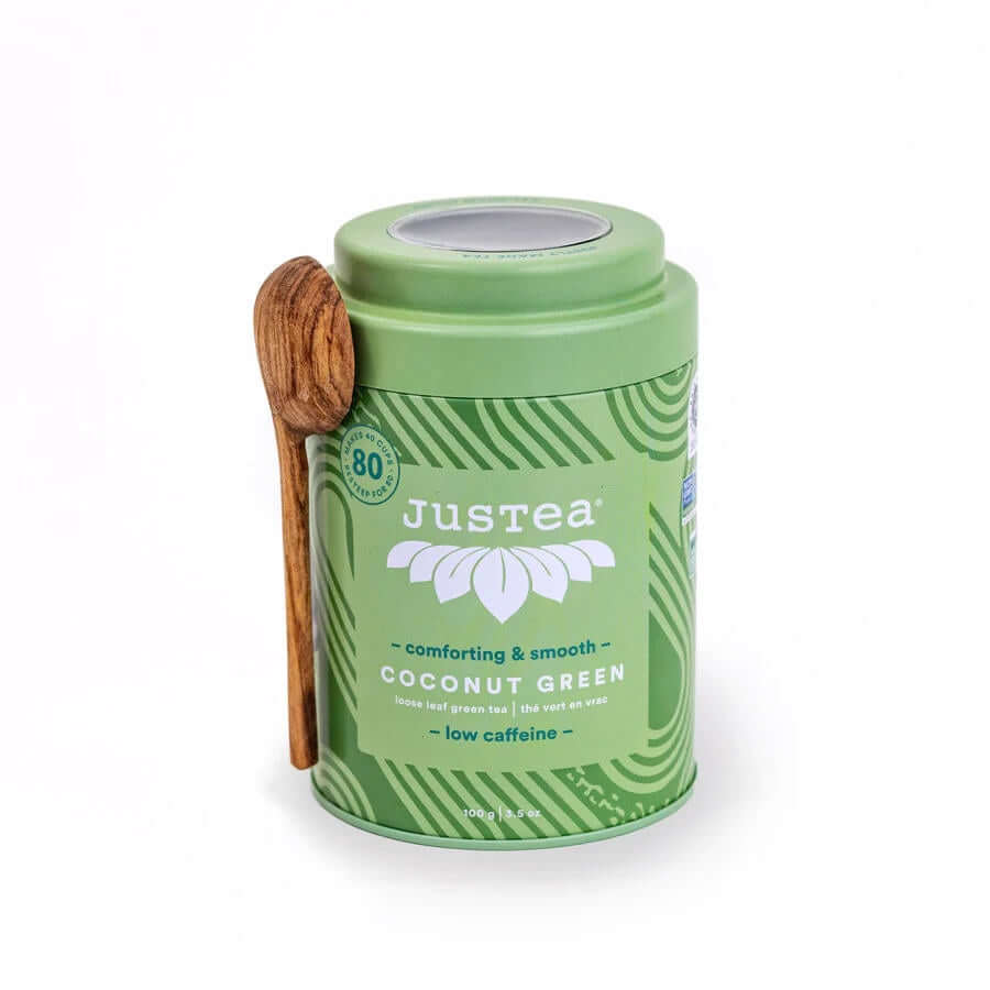 image of round metal container in light green with medium green accents and a carved wooden spoon