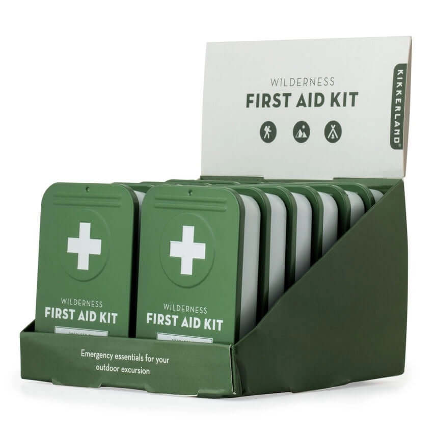 image of a box holding several of the first aid kits -- a white box with a green lid and a white cross on it