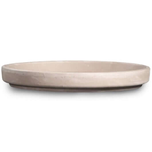 image of saucer from side, showing round light tan saucer with mottled finish