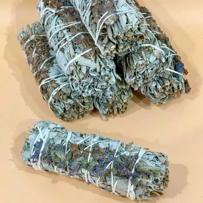 image of a stack of bundles of sage and lavender flowers, with a single bundle sitting in front
