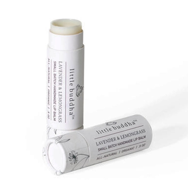 image of two round white tubes of lip balm.  One lying down and one standing up with the top off, showing the lip balm inside
