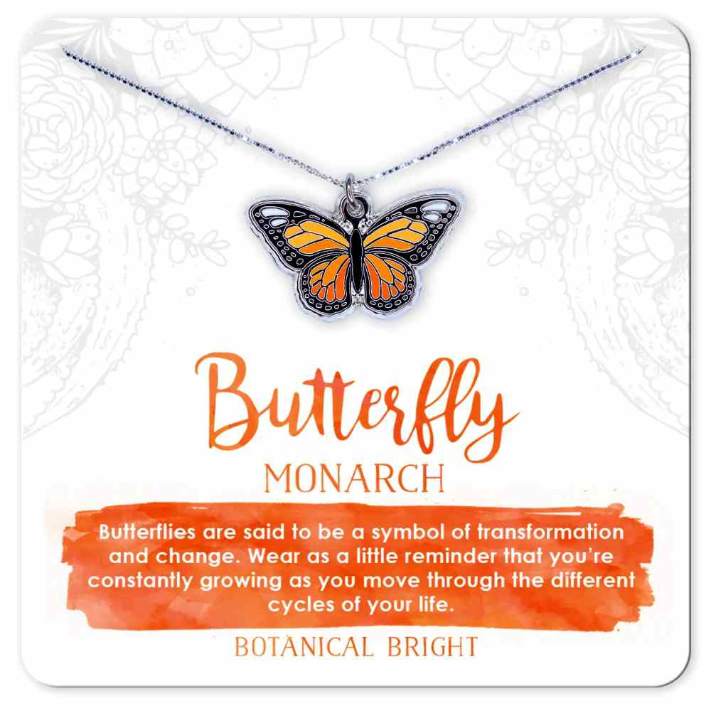 image of monarch butterfly necklace in shades of orange with black edges. On a card with description in orange and white