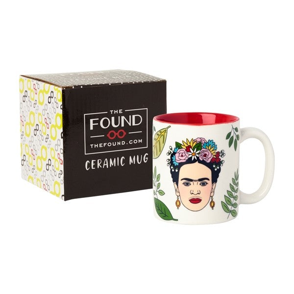 white mug with drawing of Frida Kahlo with floral crown, earrings, surrounded by leaves.  Red interior of mug