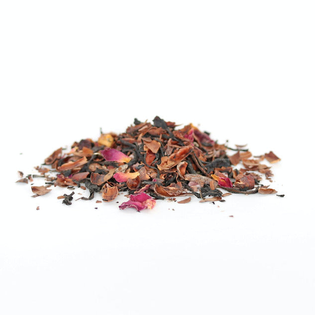 image of a small pile of dried tea leaves in colors of dark brown, golden brown, pink and yellow