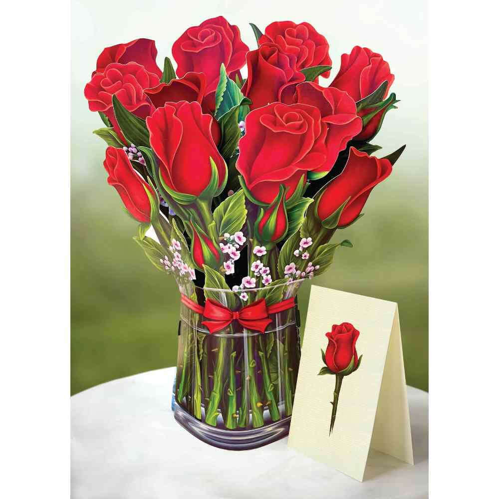 image of paper bouquet opened, featuring large red roses, small light pink blossoms, in a glass looking vase.  Small greeting card with red rose in the right forefront