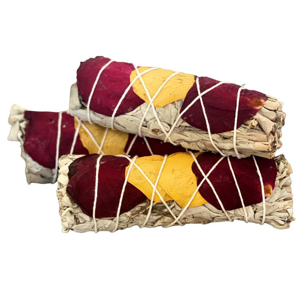 image of three oblong round bundles of sage with red and yellow rose petals wrapped in white string