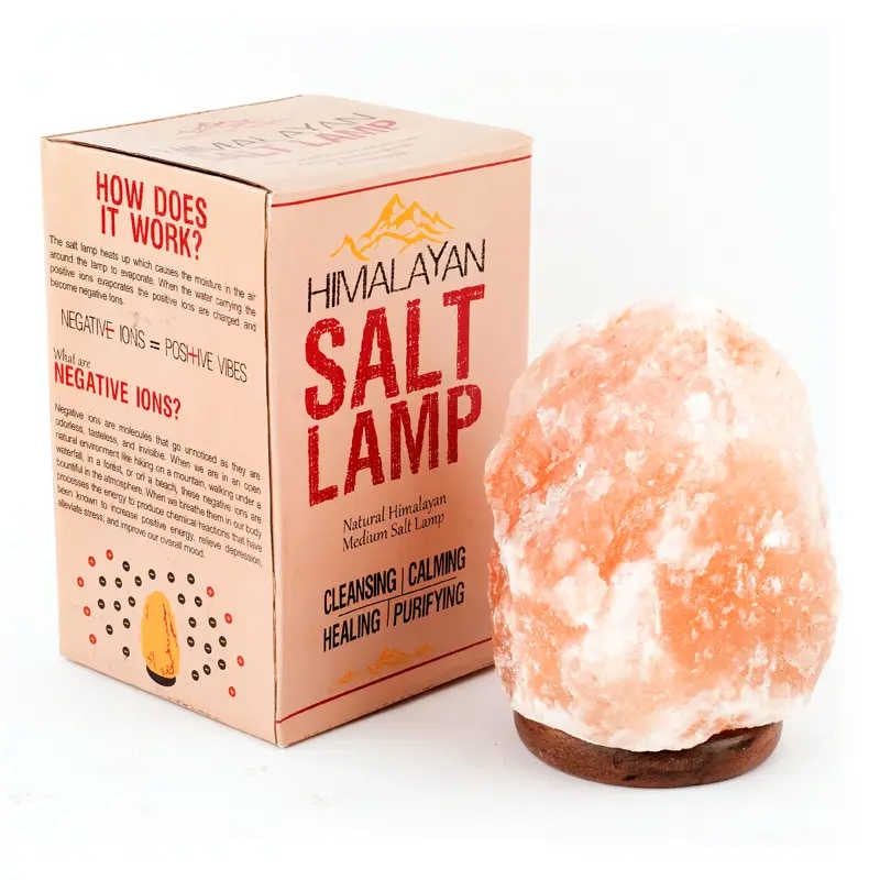 image of tall rectangular box in peach tones with himalayan salt lamp and product info written on it, next to one of the lamps, made of irregular oval shaped pink salt