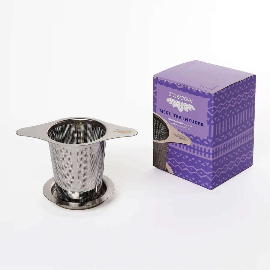 image of rectangular box in light and dark purple designs on the right, with a round stainless steel tea strainer on the left