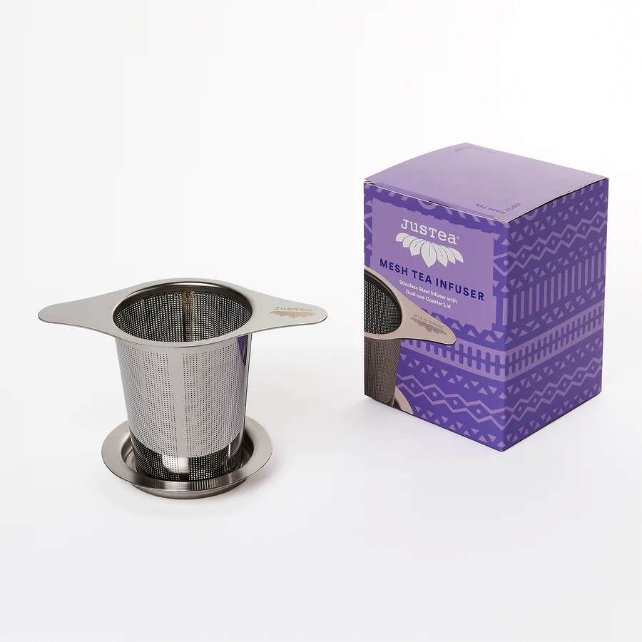 image of rectangular box in light and dark purple designs on the right, with a round stainless steel tea strainer on the left