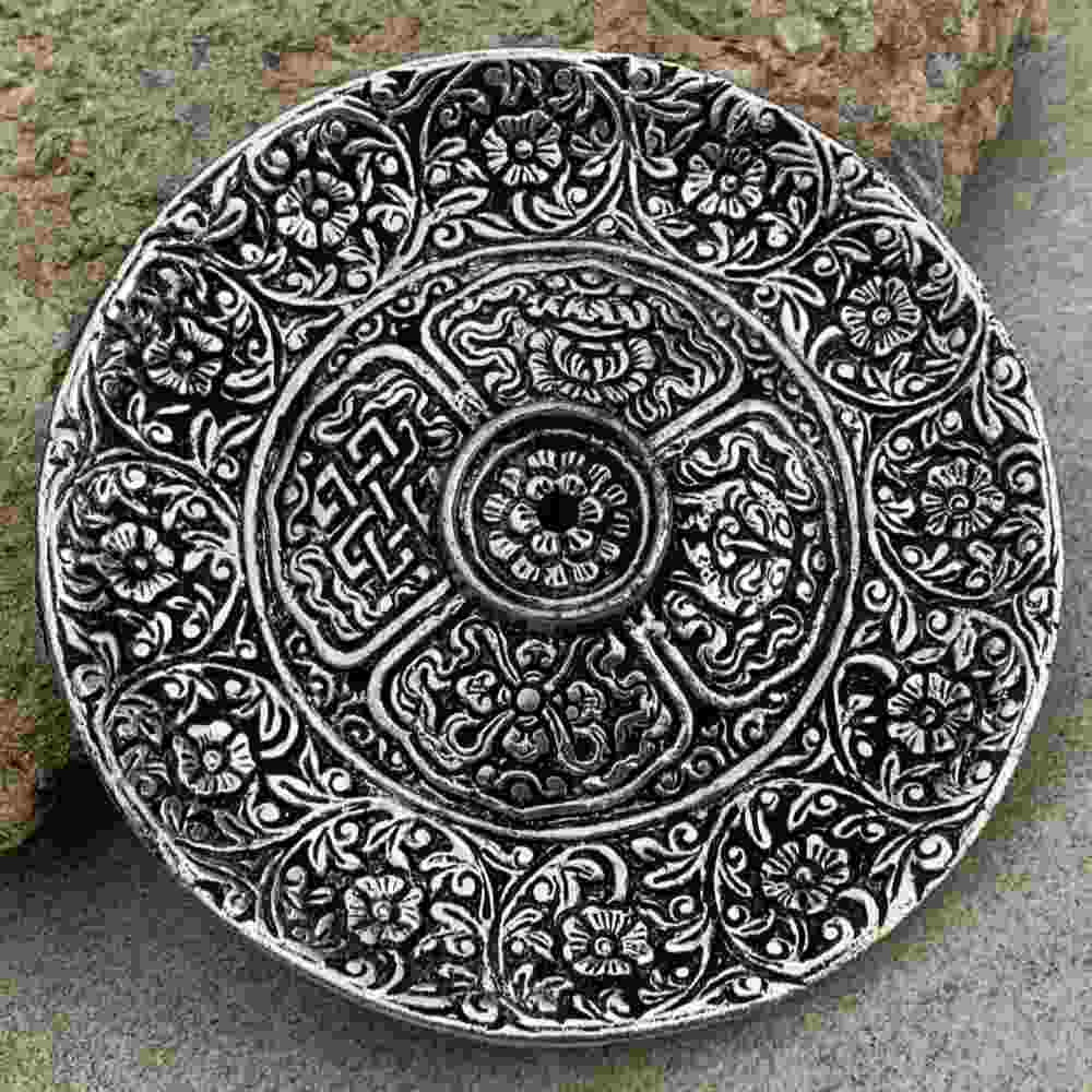 closeup image of round, intricately detailed tray